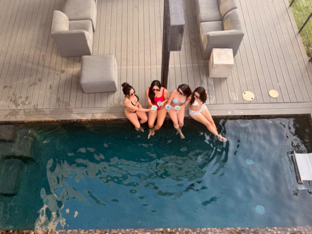 Overhead view of four women poolside