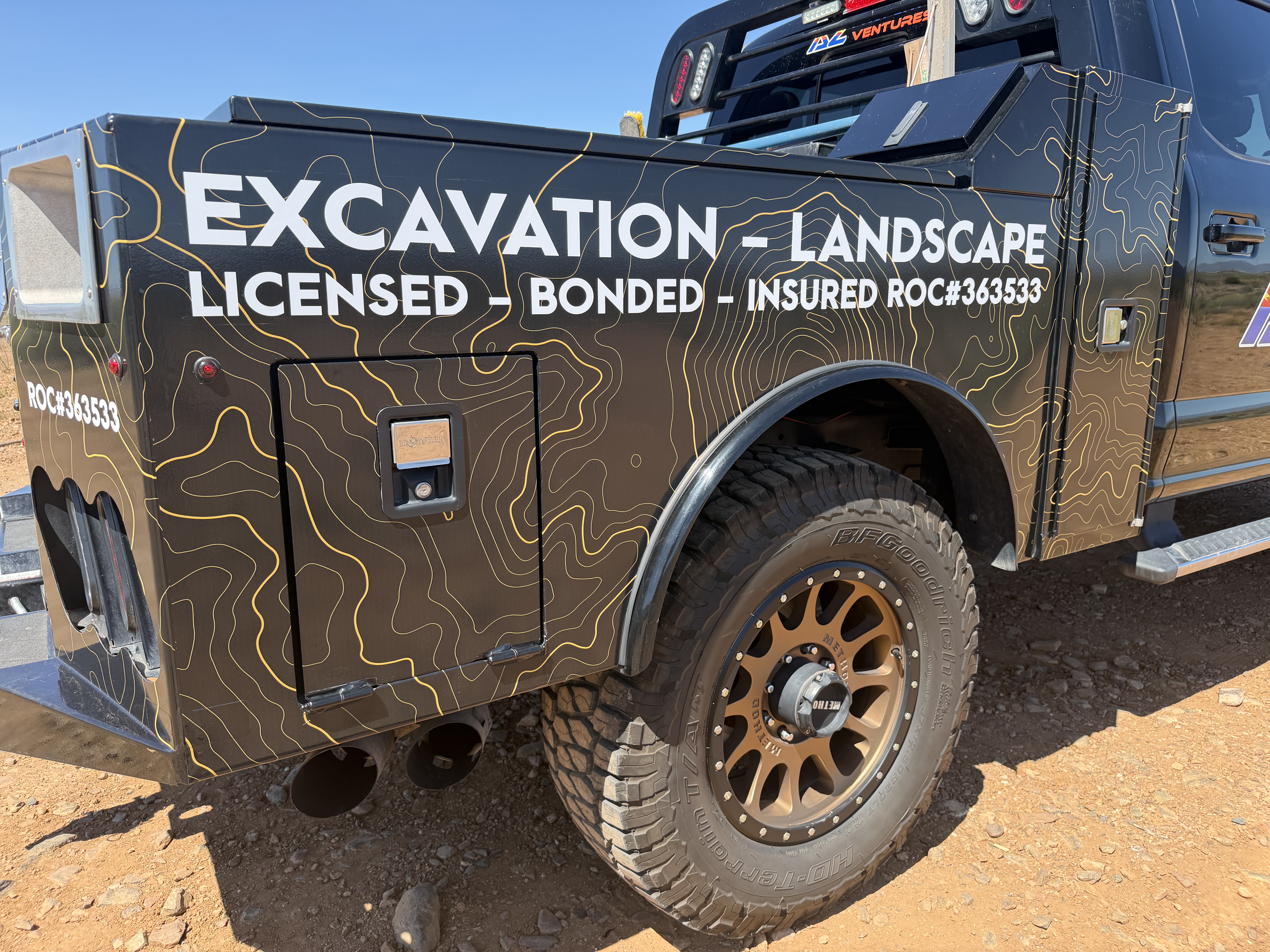 Service Body Wrap — AZ Property Ventures custom printed design with Caterpillar yellow topographic patterns | Cottonwood, AZ