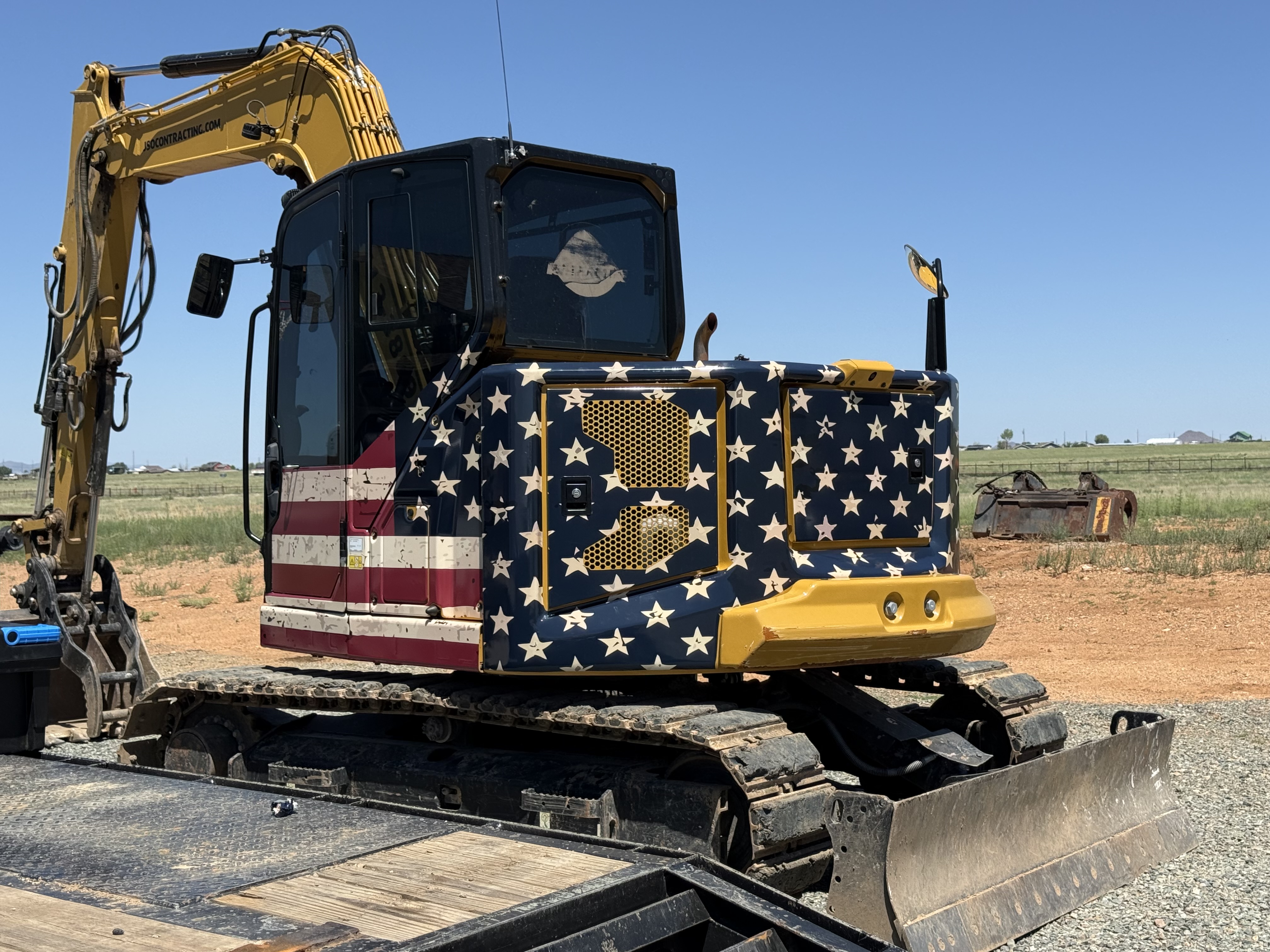 Excavator Wrap — JSO Contracting American flag vinyl wrap on Caterpillar excavator