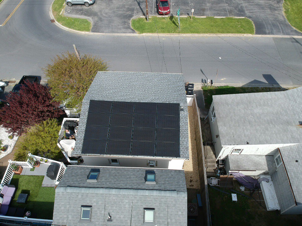 Aerial view of a rooftop solar array on a residential property.