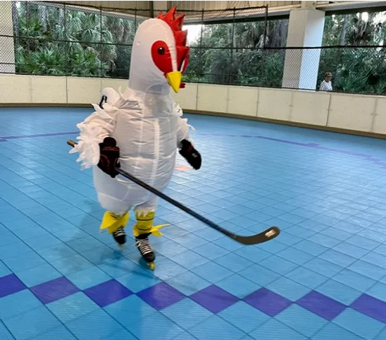 Chicken skating on athletic tile surface