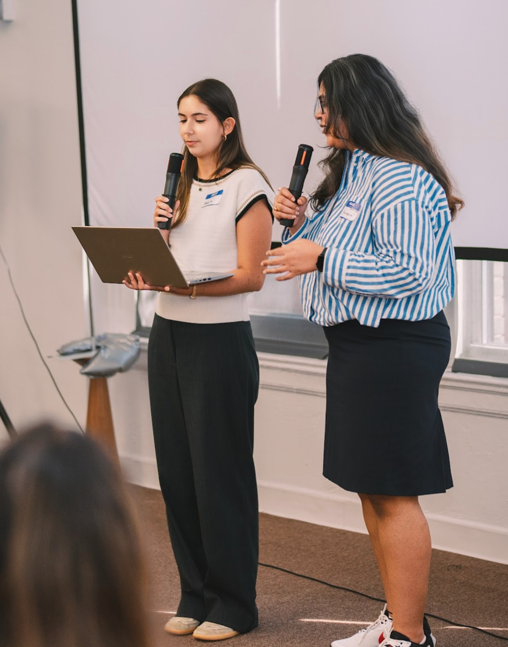 Two members presenting on stage