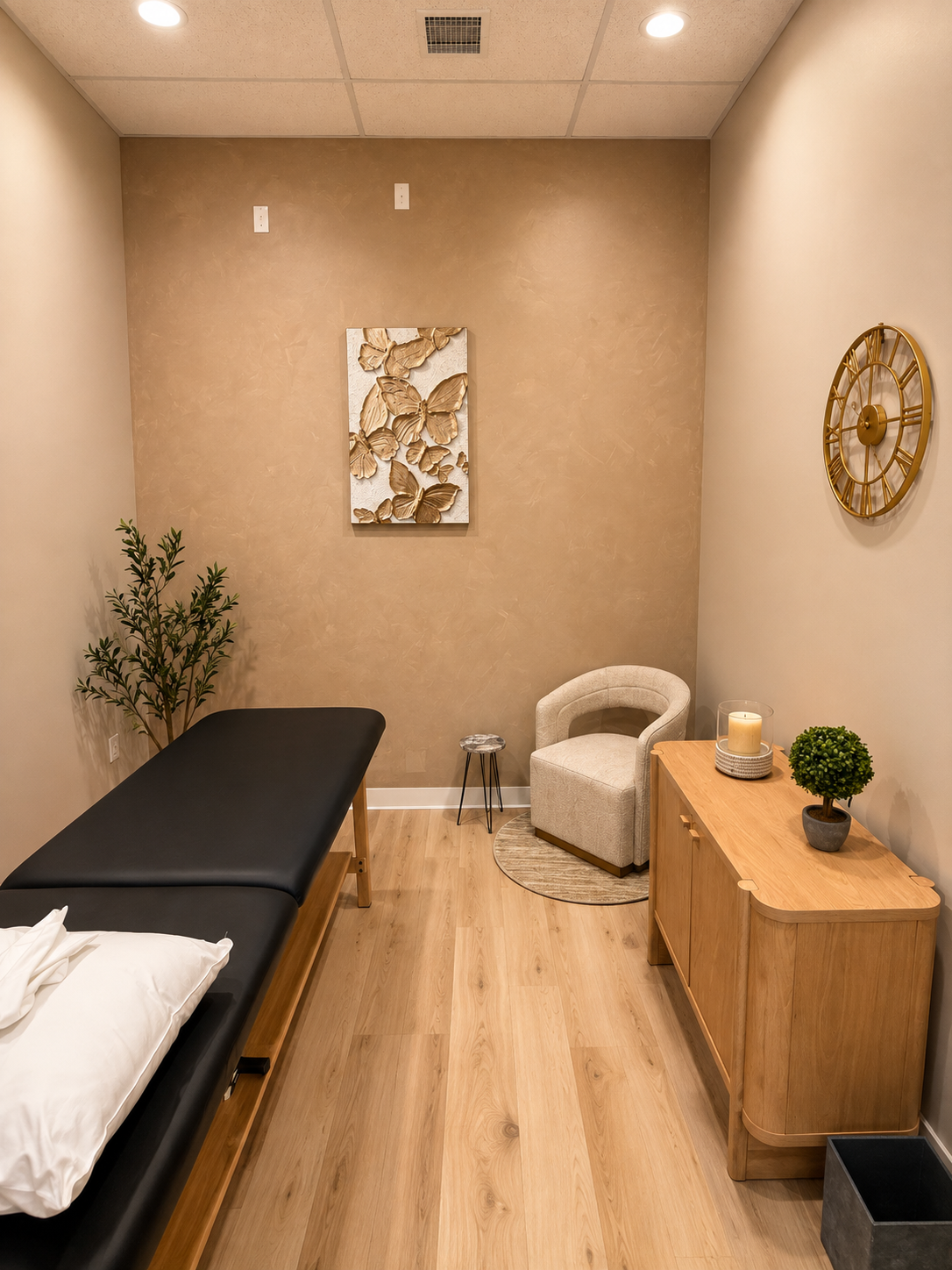 Physical therapy treatment room with treatment table and butterfly wall art