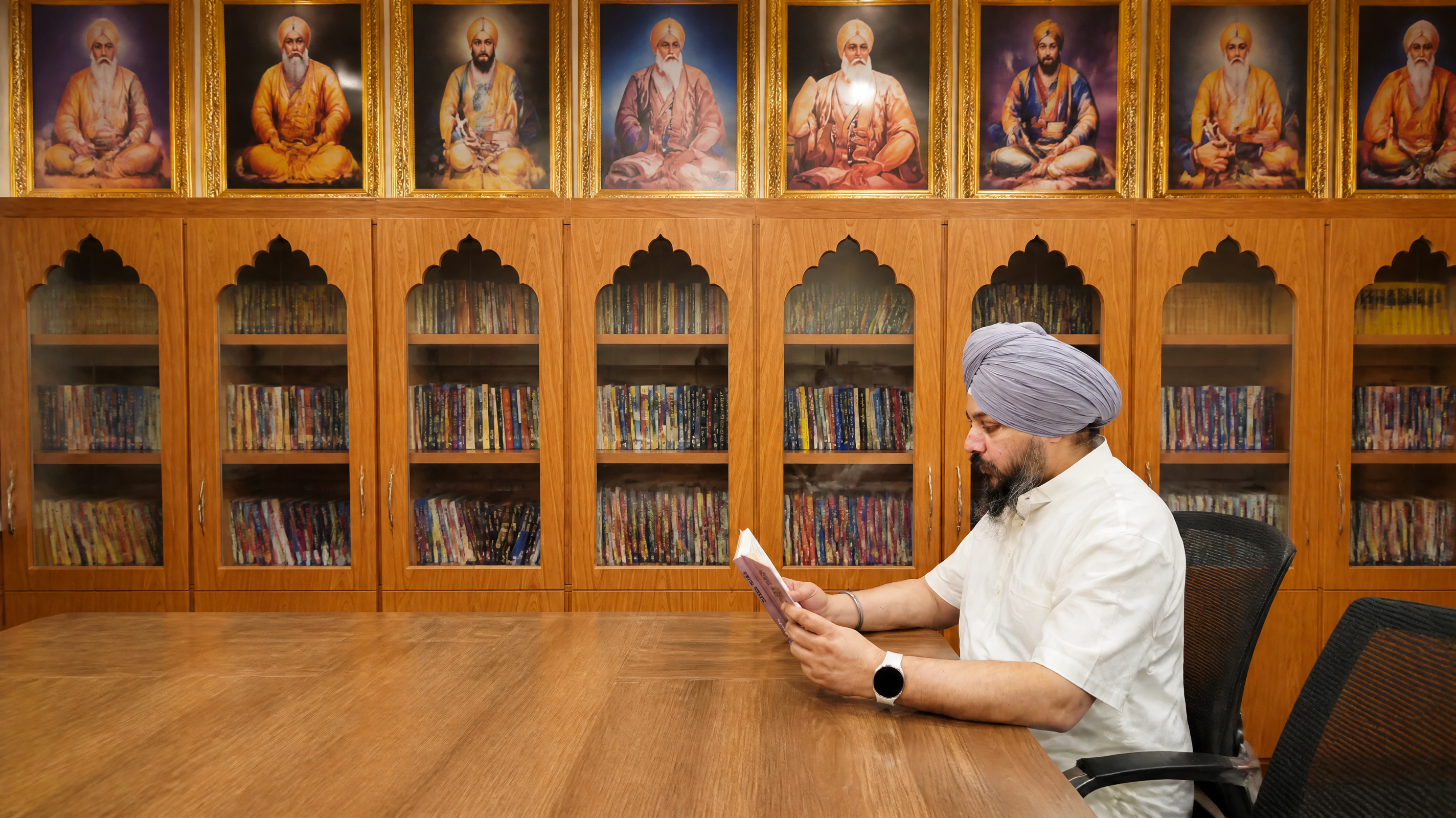 Dr. Jaswinder Singh reading in his study
