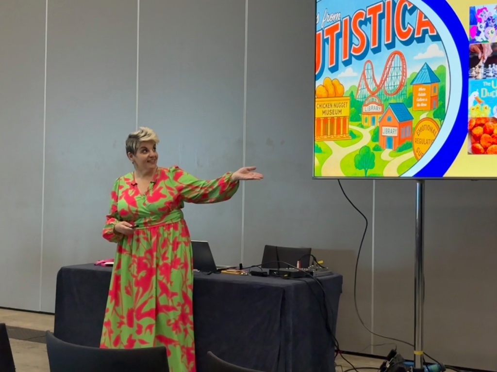 Angela speaking in green and pink dress