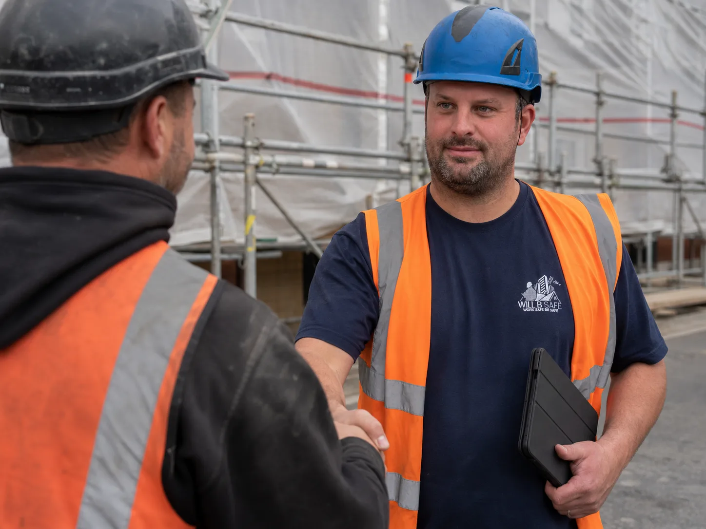 Jamie Will on site with a tablet during a scaffold inspection
