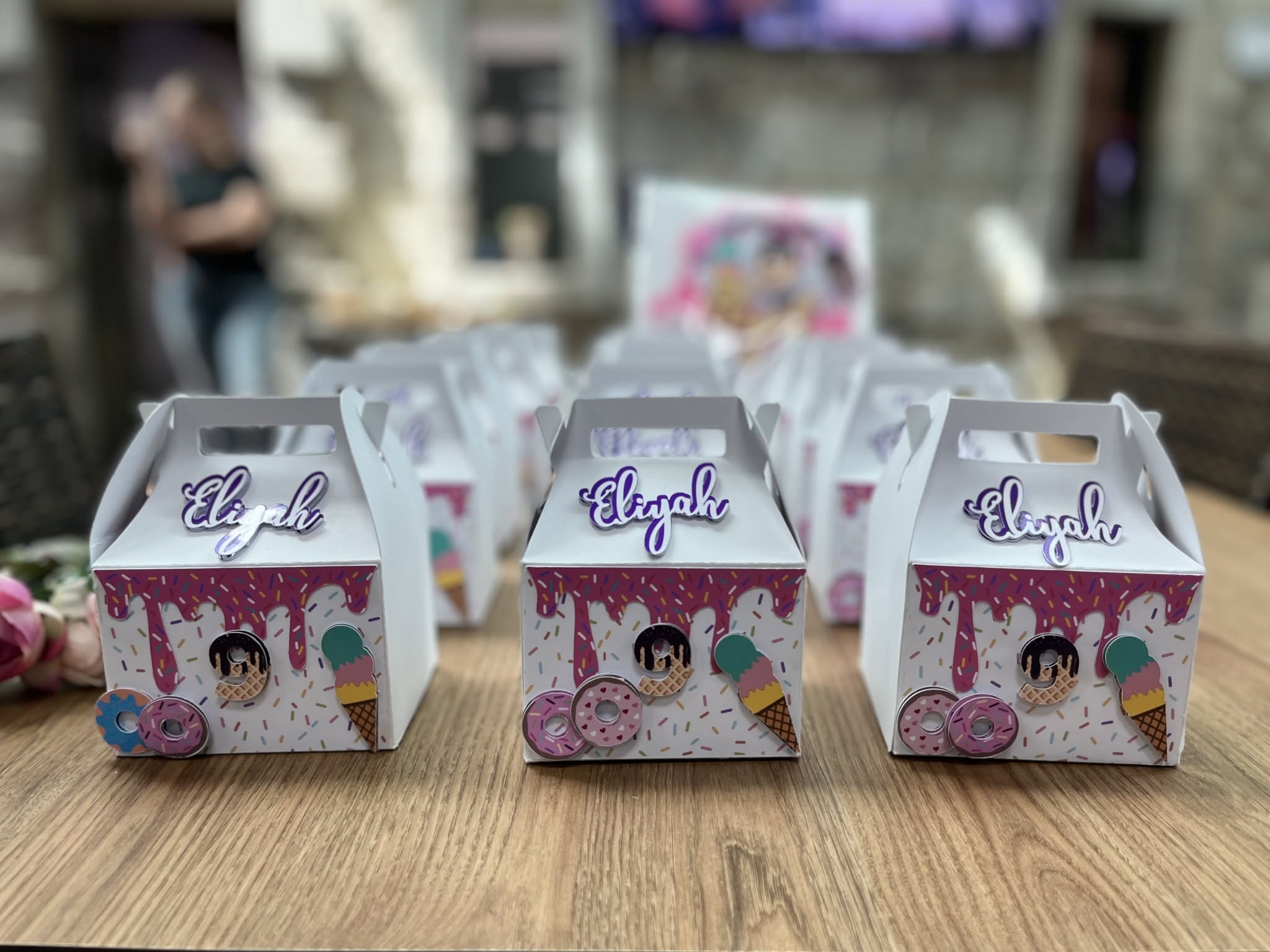 Dripping-icing party boxes with 3D treats for Elijah's celebration.