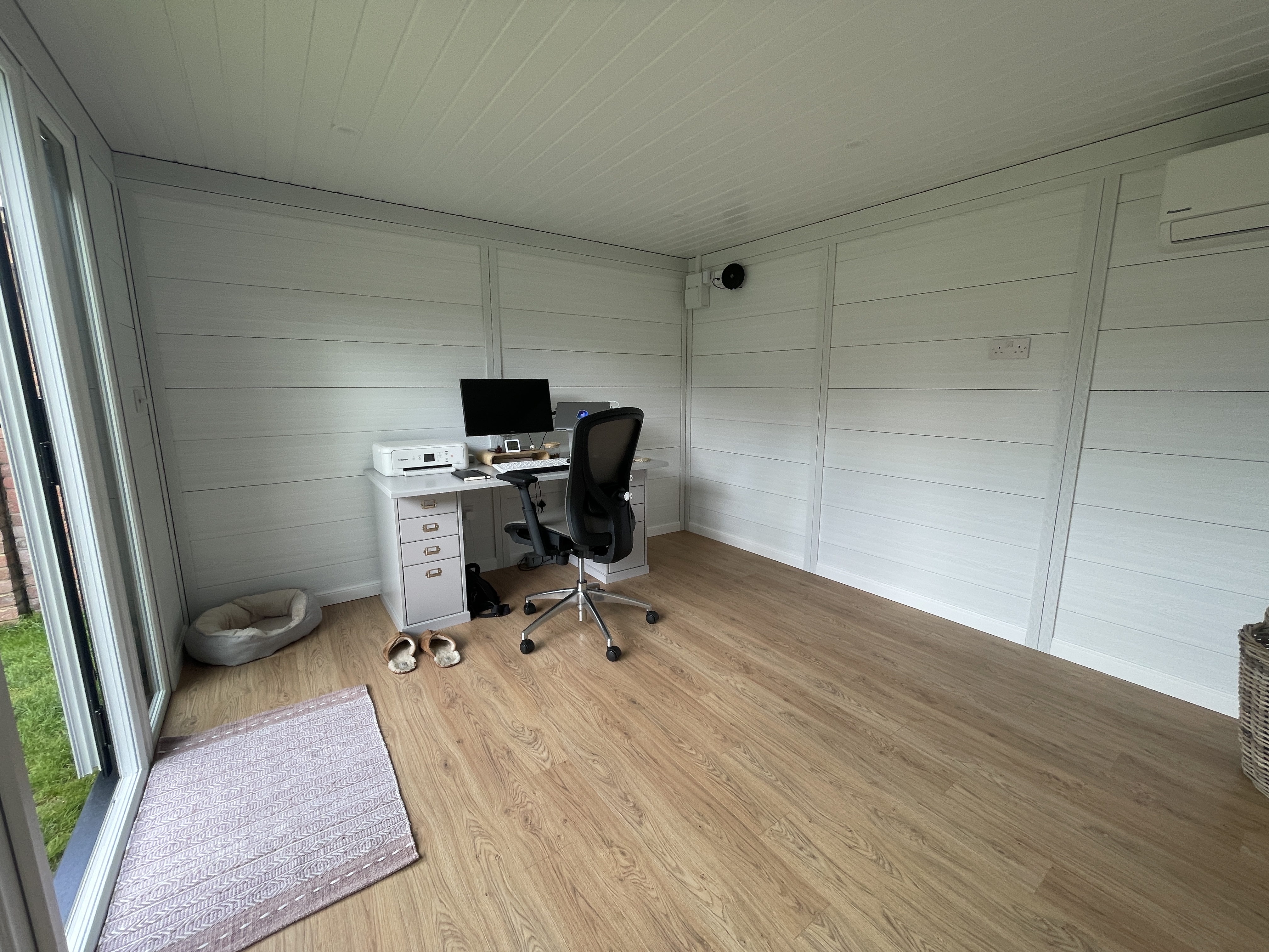 Finished garden room interior with ceiling, lighting, and flooring