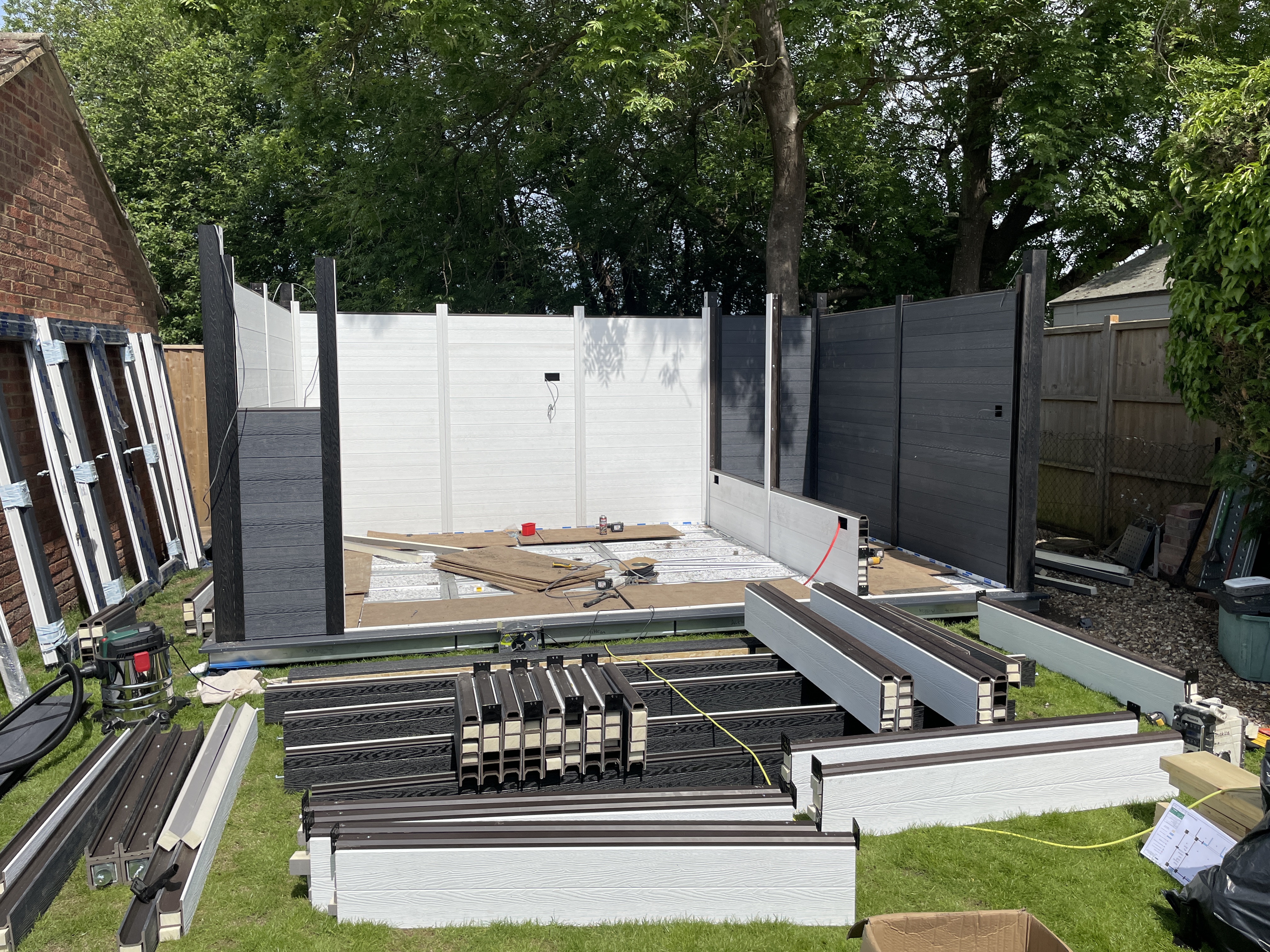 Composite wall panels being installed on a garden room