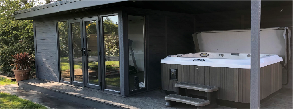 Composite-clad garden room exterior with covered deck and hot tub