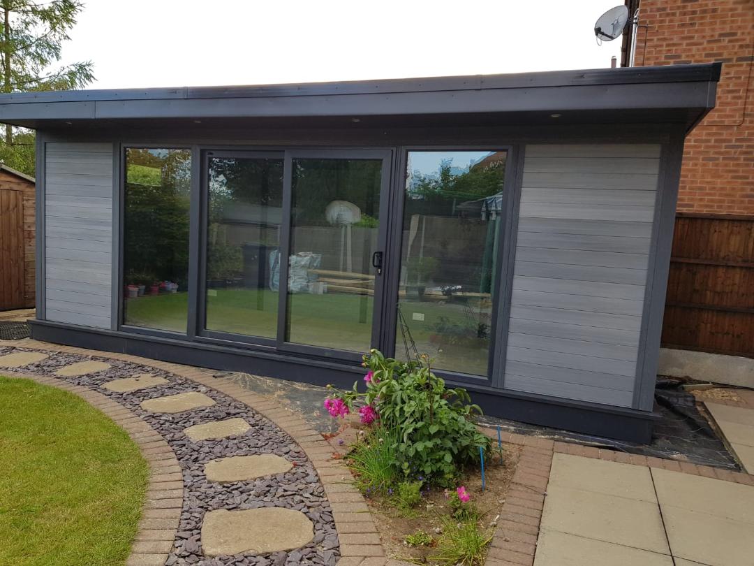 Modern flat-roof garden room with bi-fold doors