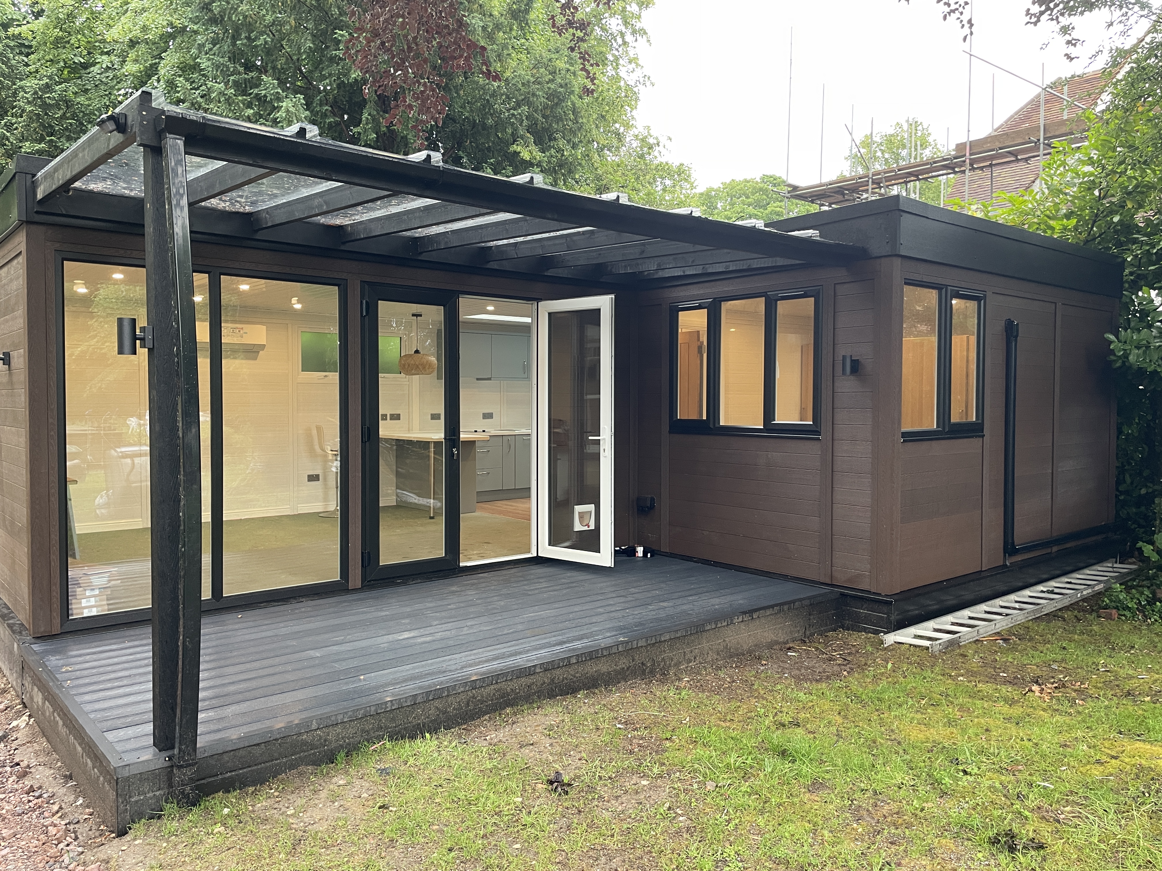 Garden annexe exterior with glass canopy and French doors