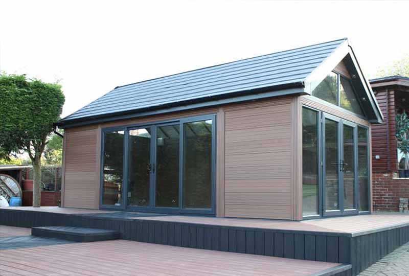 Pitched-roof garden room with composite cladding and folding doors