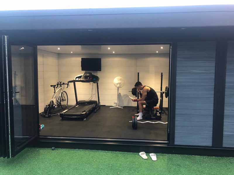 Garden gym exterior with bi-fold doors open