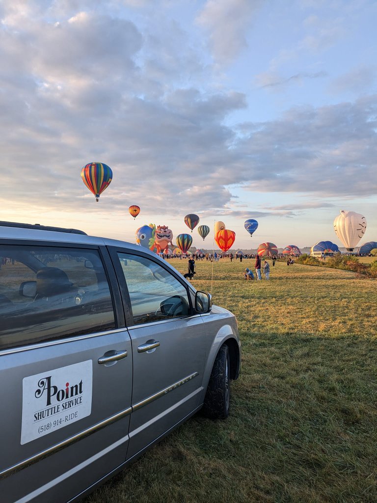 APoint Shuttle van at a balloon festival