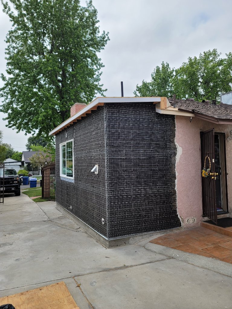 Black stucco mesh and lath applied to full exterior walls of room addition California