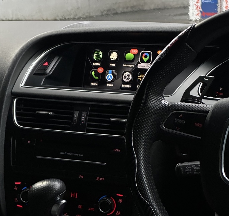 Audi dashboard showing wireless Apple CarPlay running on the factory screen