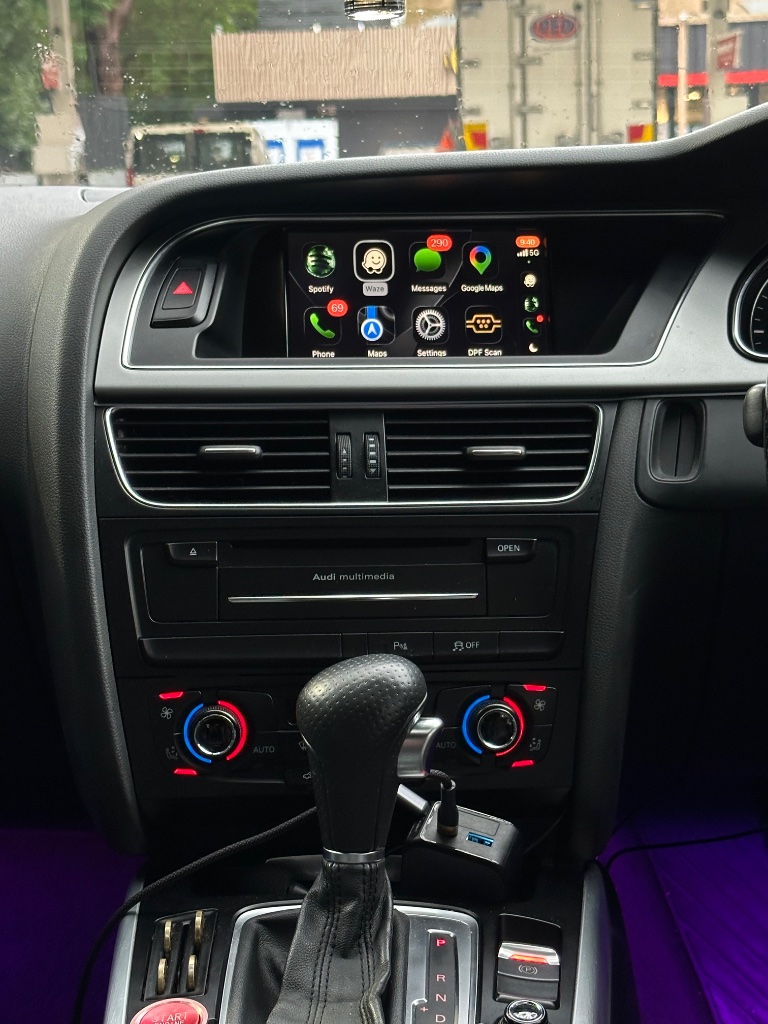 CarPlay app grid — Spotify, Maps, Messages
