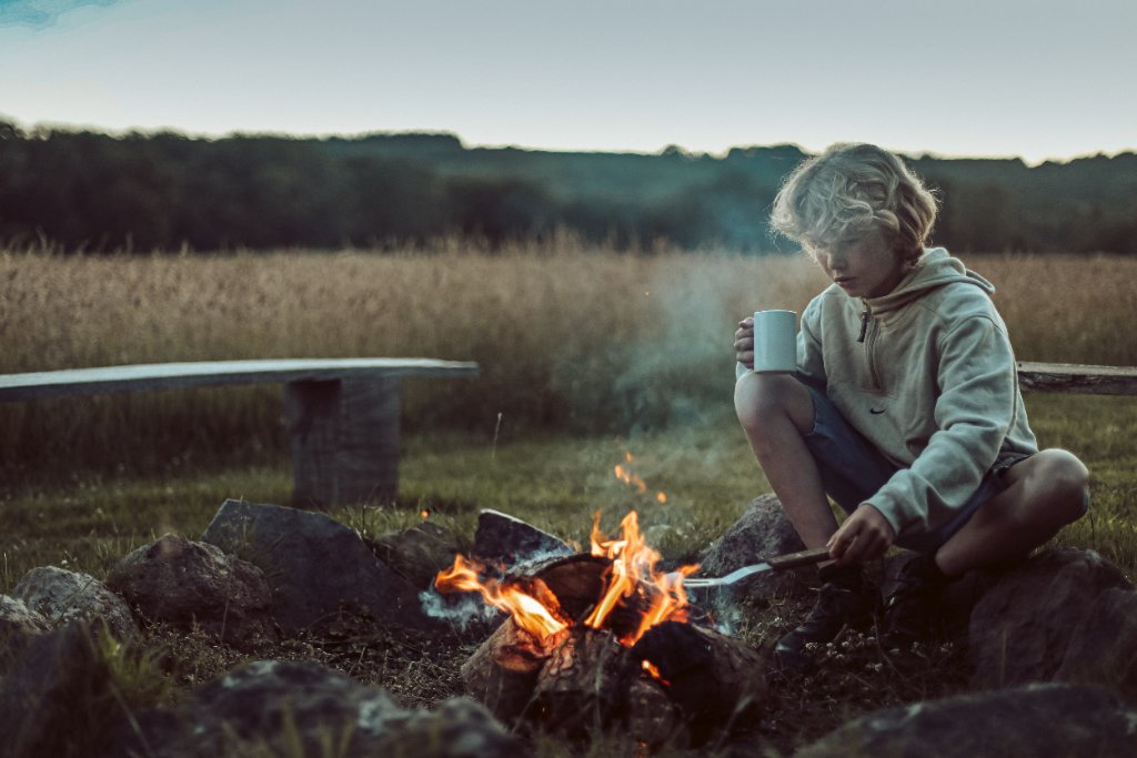Child by a campfire at Night Pastures