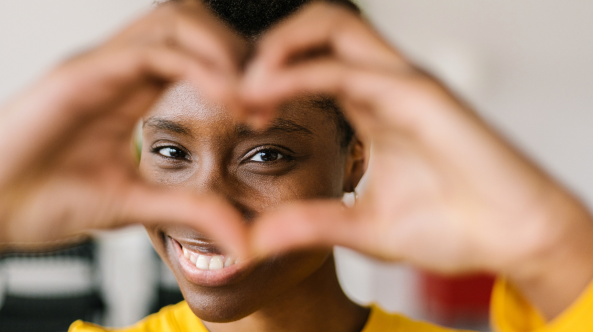 Young lady making a heart gesture