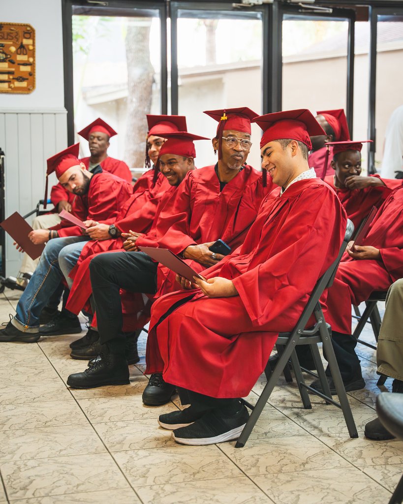 Father First graduates in red gowns
