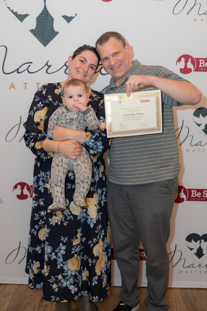 Family holding their certificate of completion