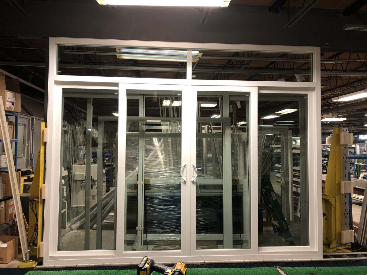 Four-panel sliding patio door with transom window