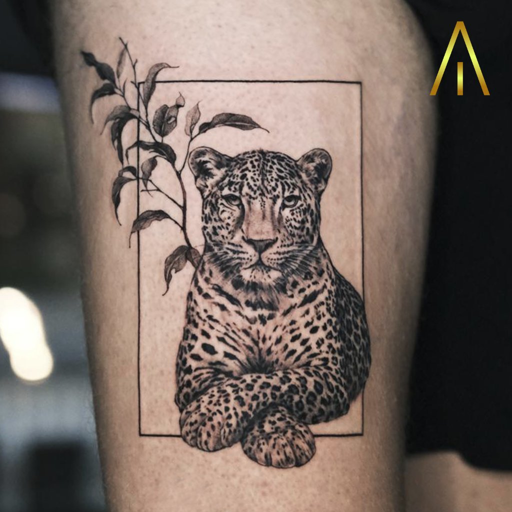 Black and grey leopard in frame tattoo on thigh Chiang Mai