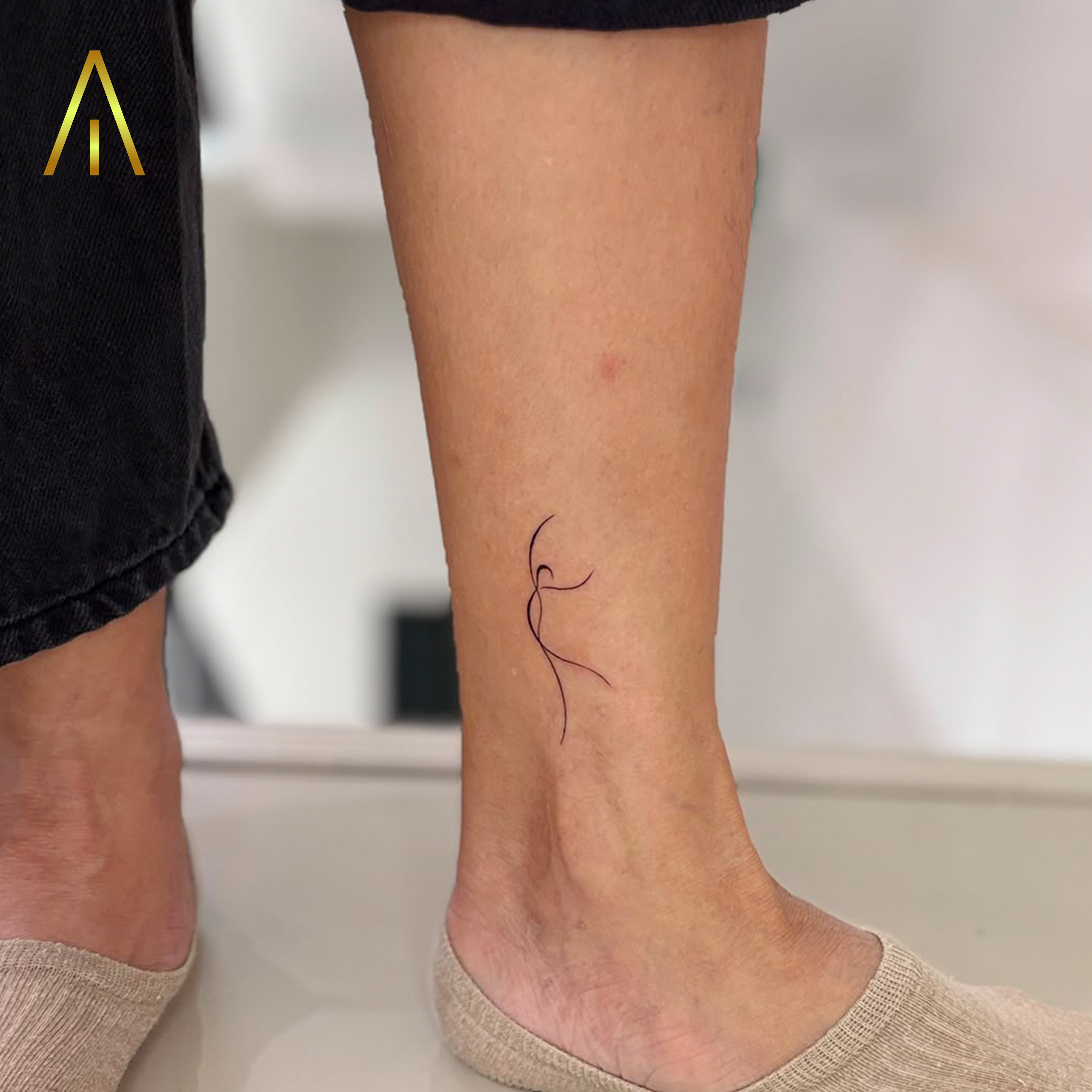 Fine line minimalist dancing figure calf tattoo Chiang Mai