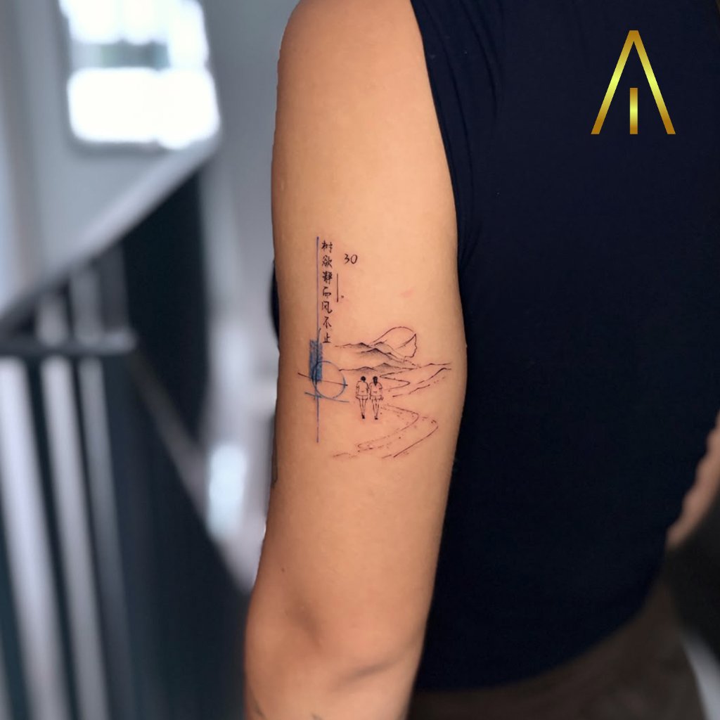 Minimal figures and mountains with Chinese characters tattoo on upper arm Chiang Mai
