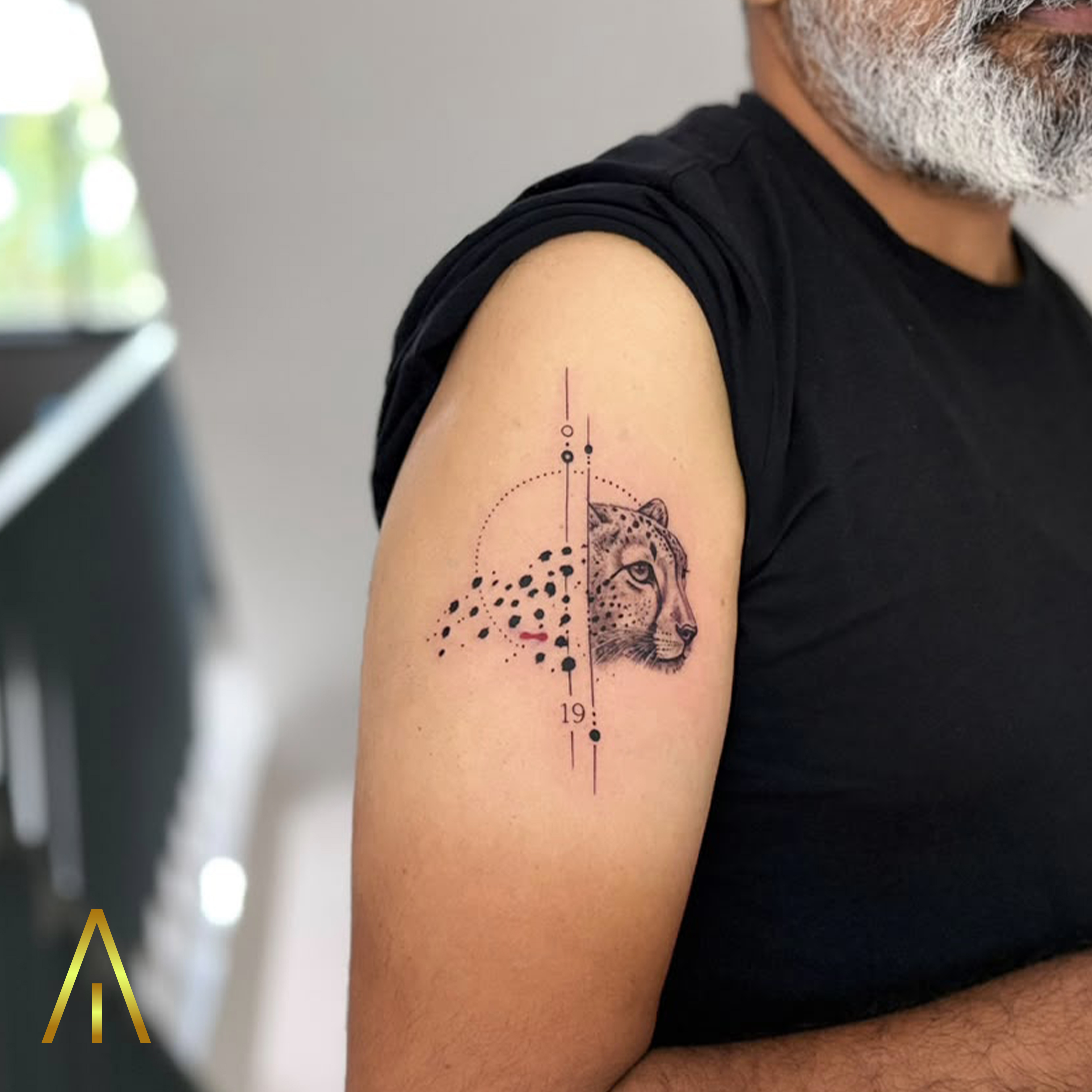 Katie leopard head and dotted geometric pattern minimal upper arm tattoo Chiang Mai