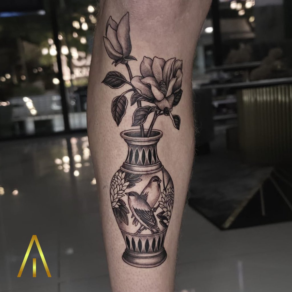 Blackwork vase with birds and flowers tattoo on leg Chiang Mai