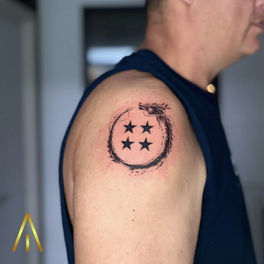 Minimal ouroboros with stars tattoo on upper arm Chiang Mai