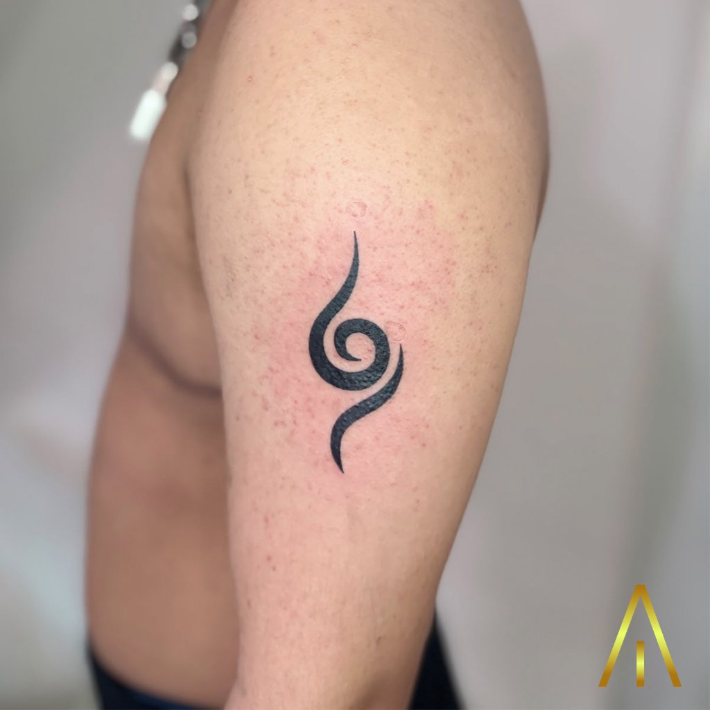 Minimal spiral symbol tattoo on upper arm Chiang Mai