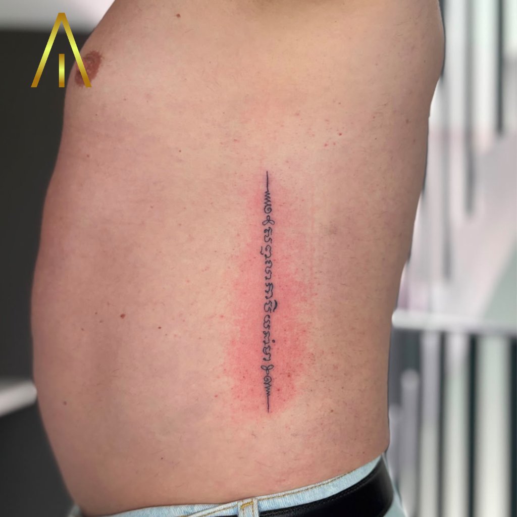 Sak Yant Thai script tattoo on ribcage Chiang Mai