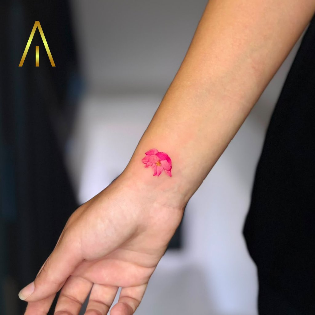 Colour pink lotus bud fine line tattoo on wrist Chiang Mai