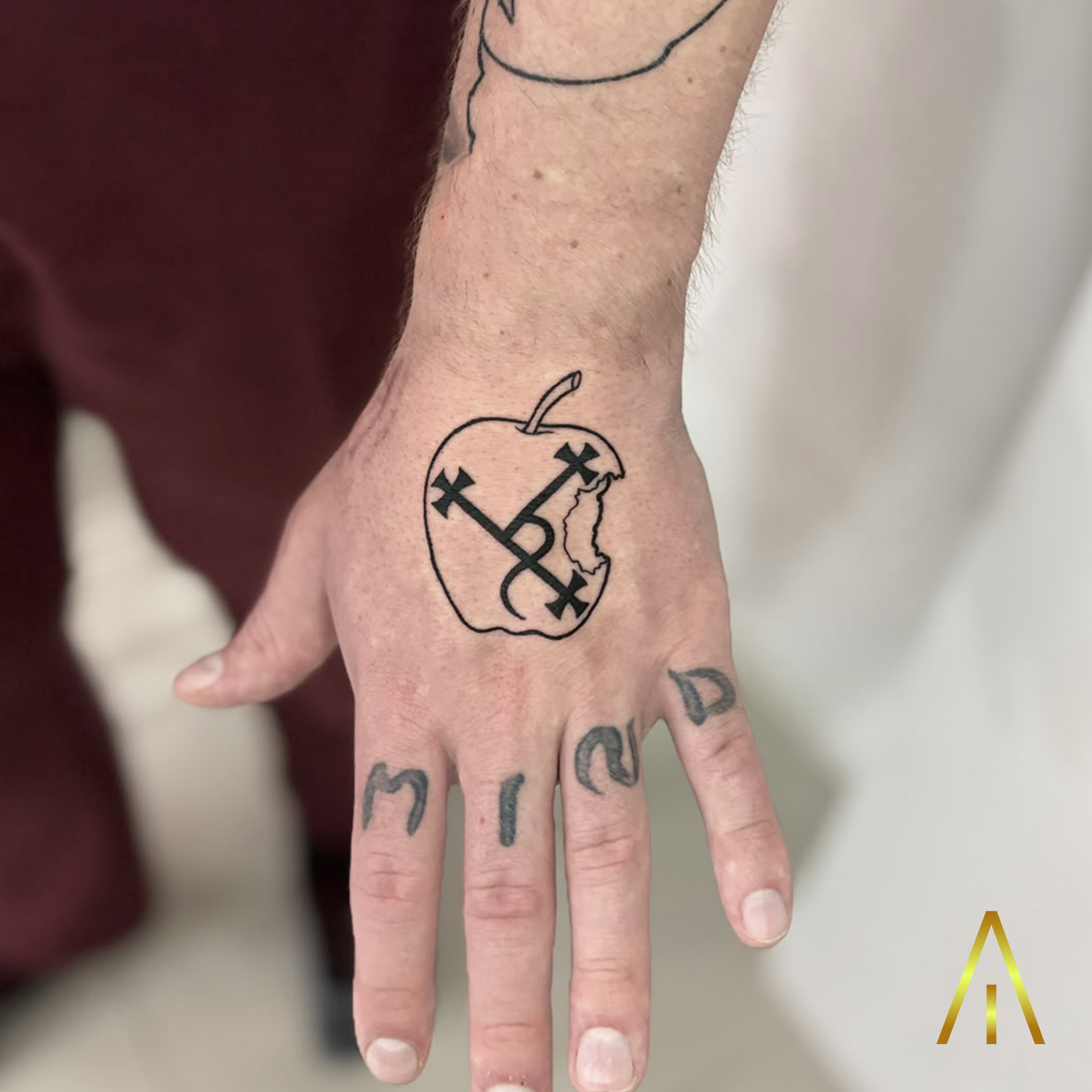 Mimi apple with cross symbol and MIND lettering minimal hand tattoo Chiang Mai