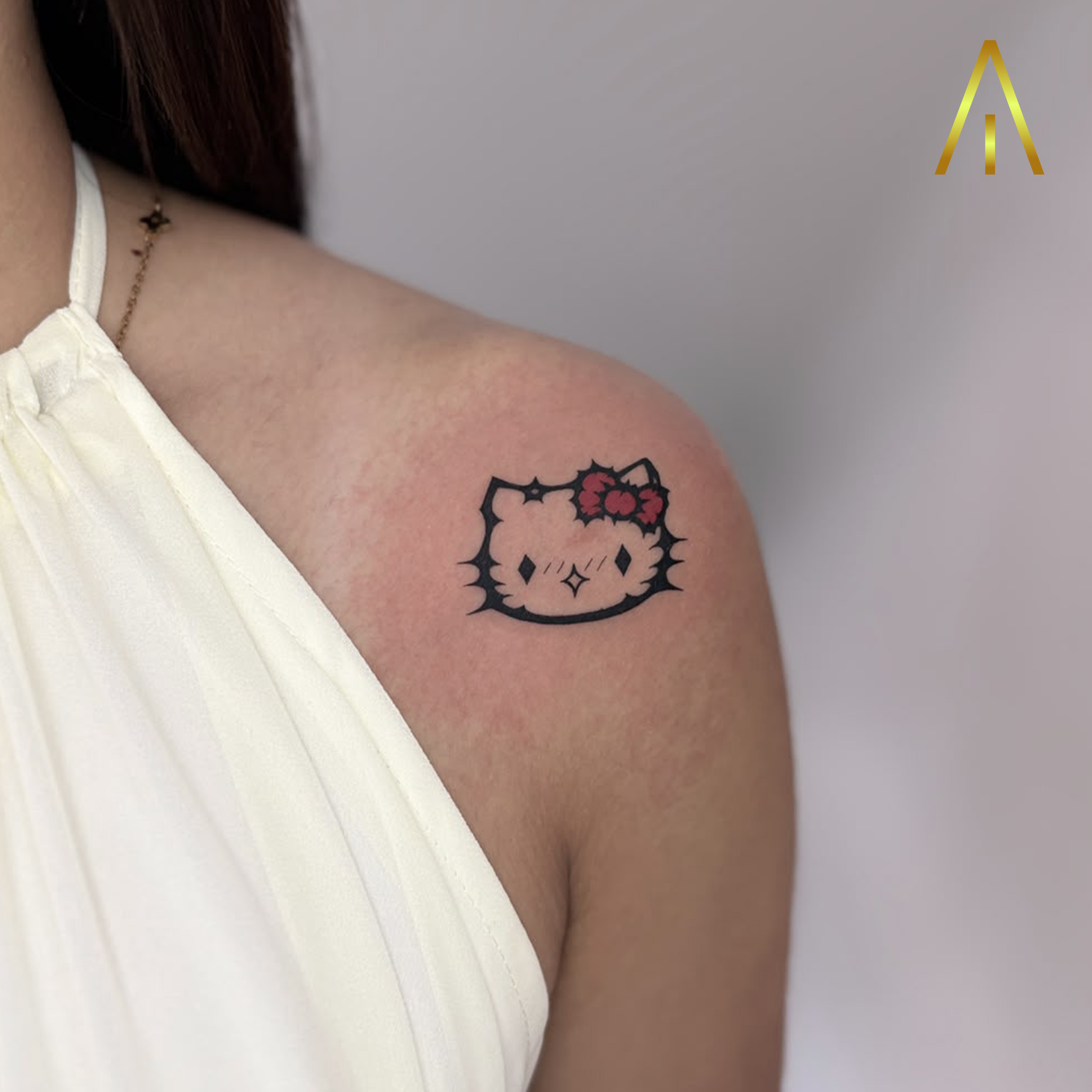 Katie minimal Hello Kitty with red bow shoulder tattoo Chiang Mai