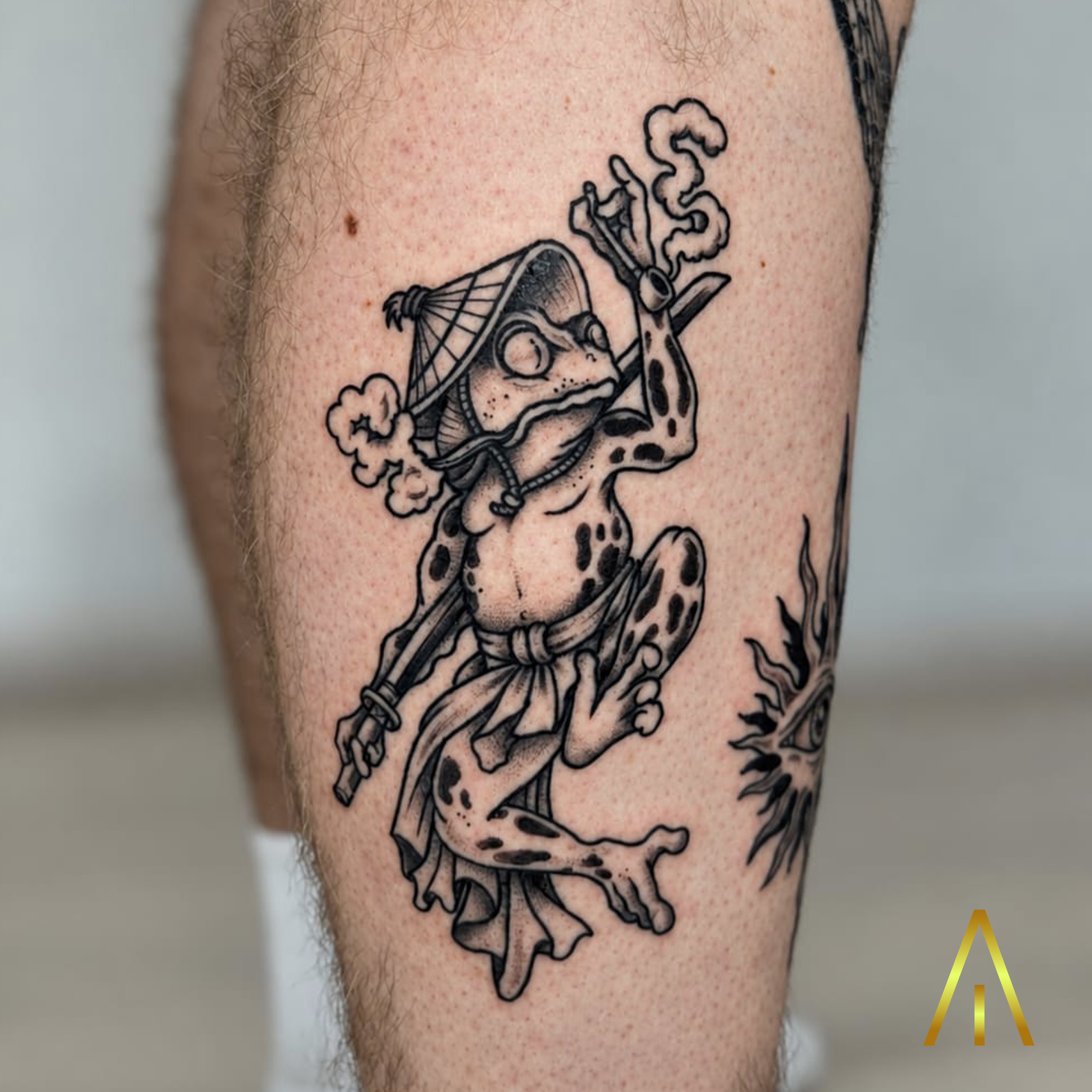 Katie Japanese frog with pipe and kasa hat minimal calf tattoo Chiang Mai