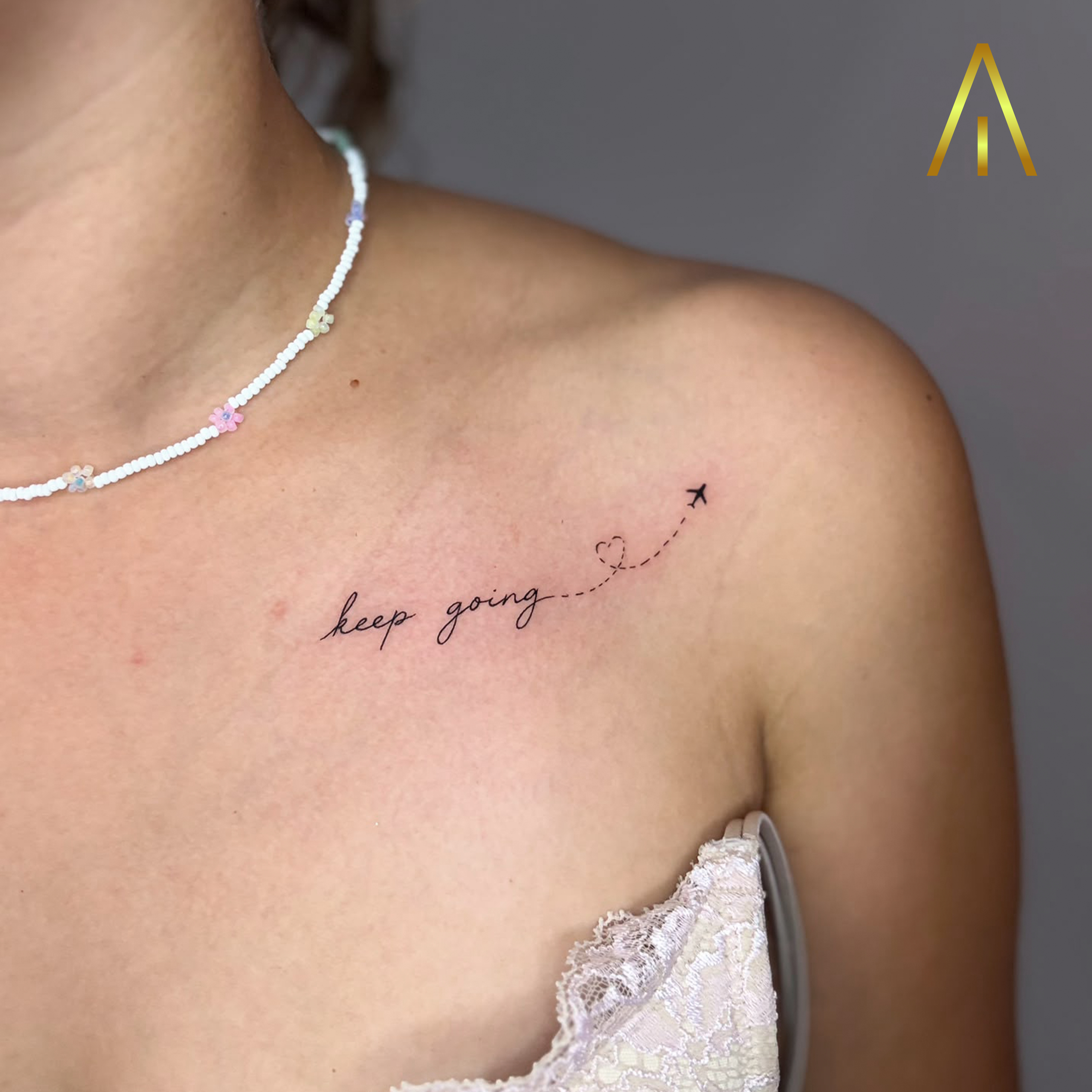 Keep going script with airplane and heart fine line tattoo Chiang Mai