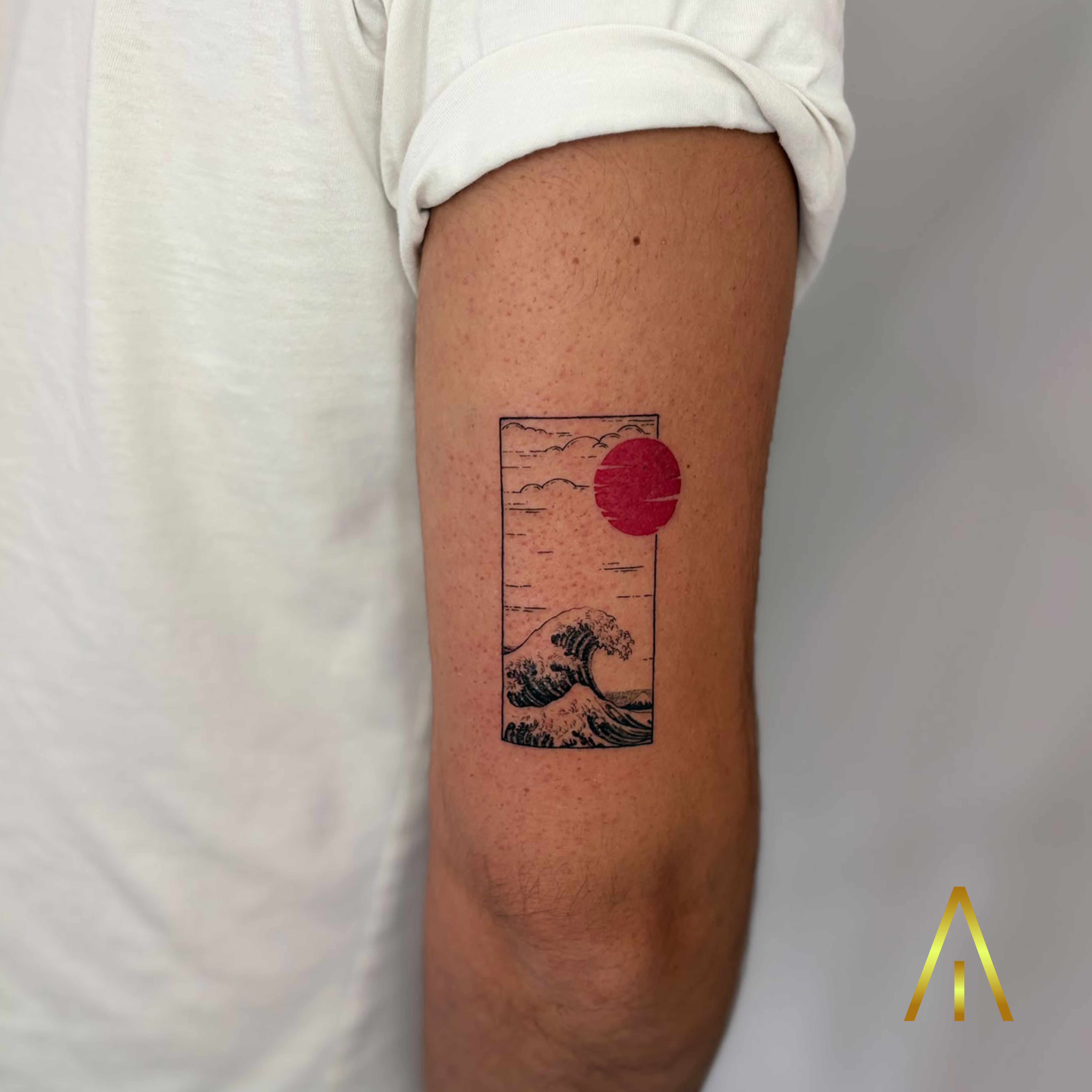 Mimi minimal Great Wave with red sun framed upper arm tattoo Chiang Mai