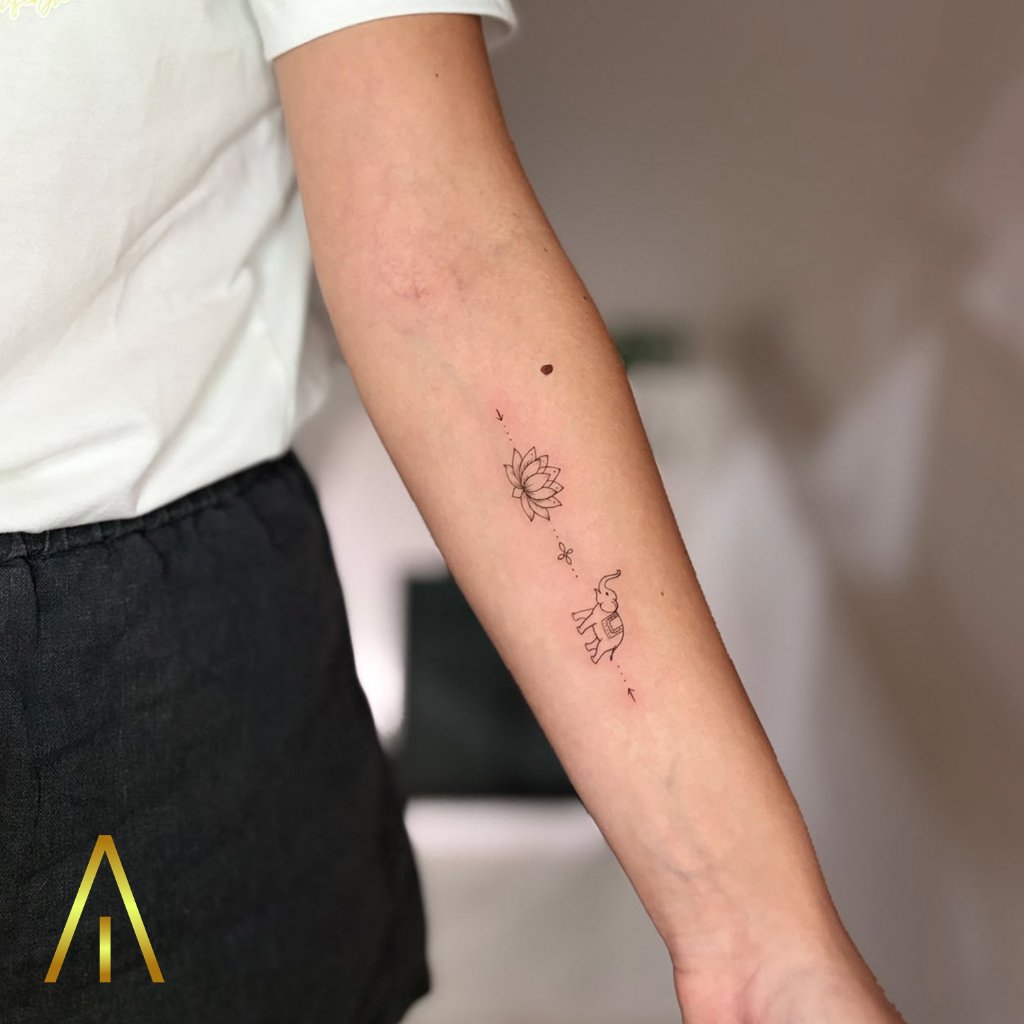 Fine line lotus elephant dotted line tattoo on forearm Chiang Mai
