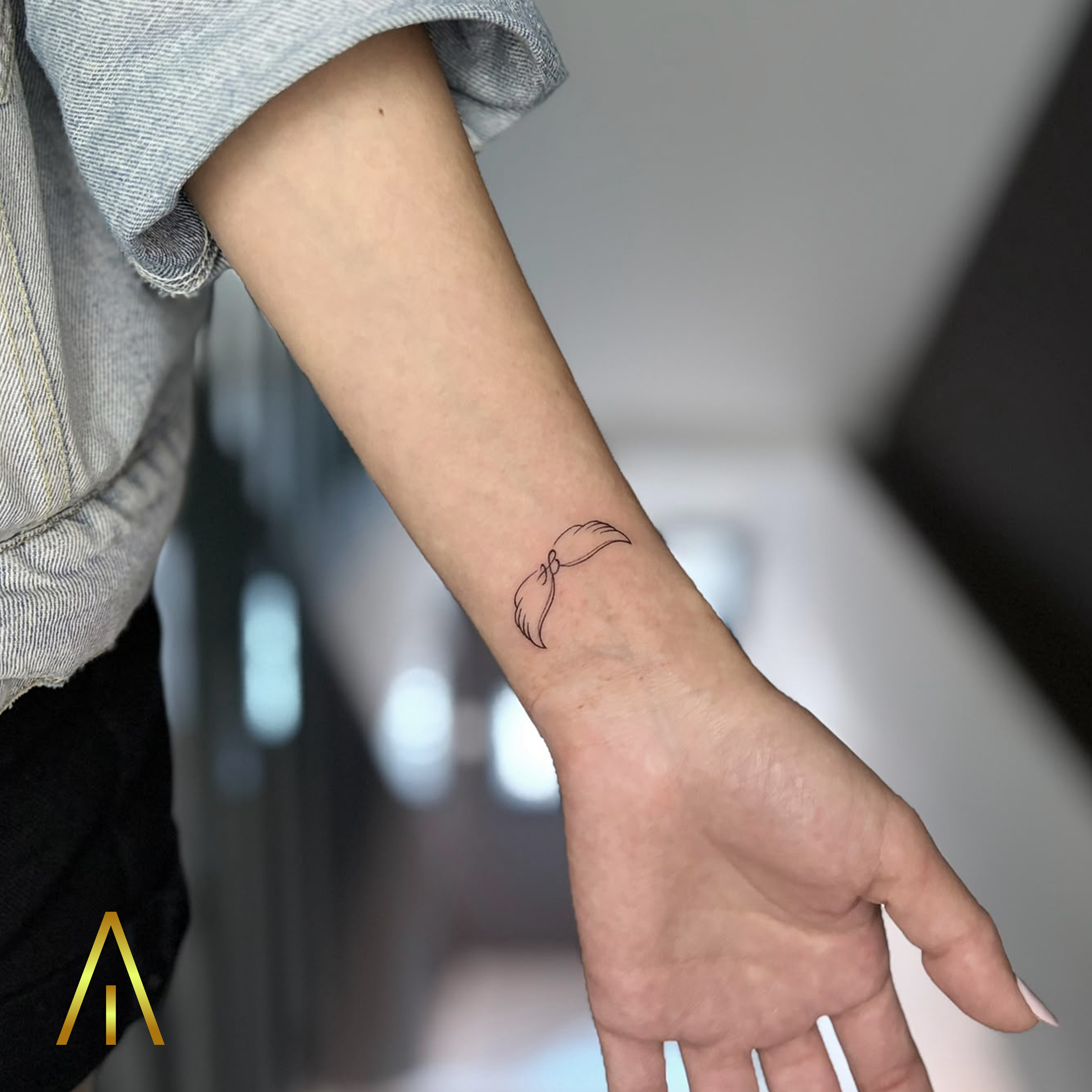 Mimi minimalist wings fine line inner wrist tattoo Chiang Mai