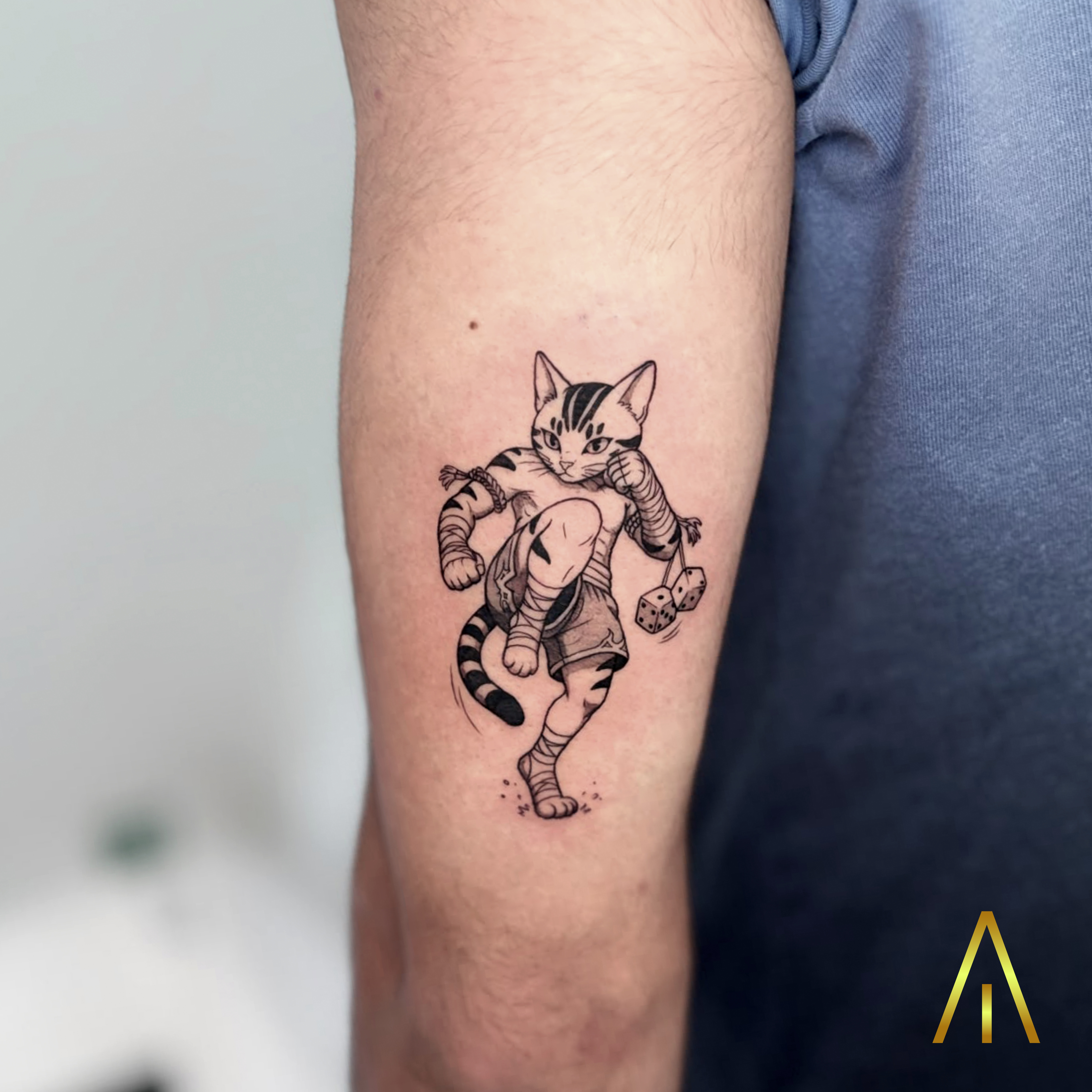 Minimal Muay Thai cat upper arm tattoo Chiang Mai