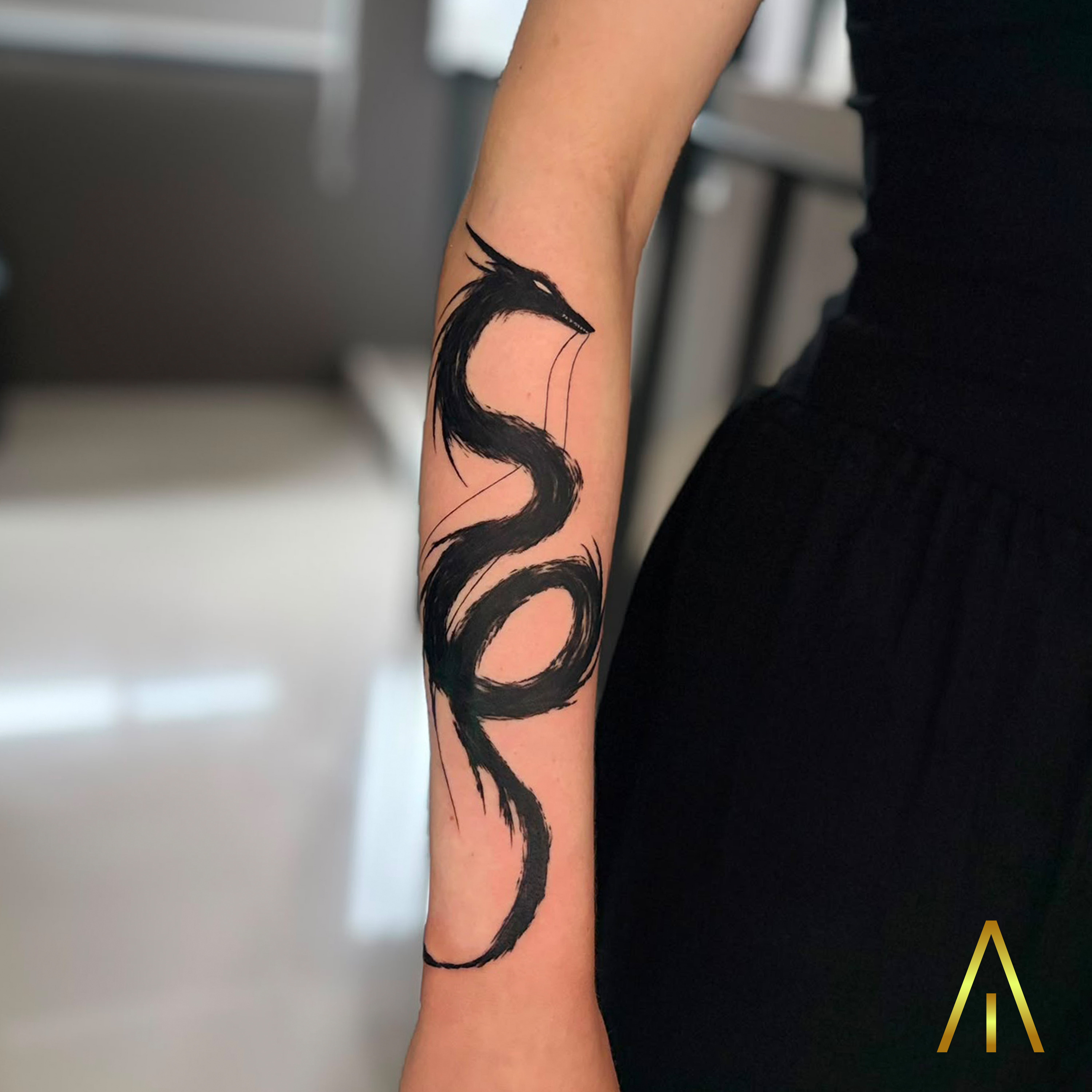 Blackwork brushstroke dragon forearm tattoo Chiang Mai