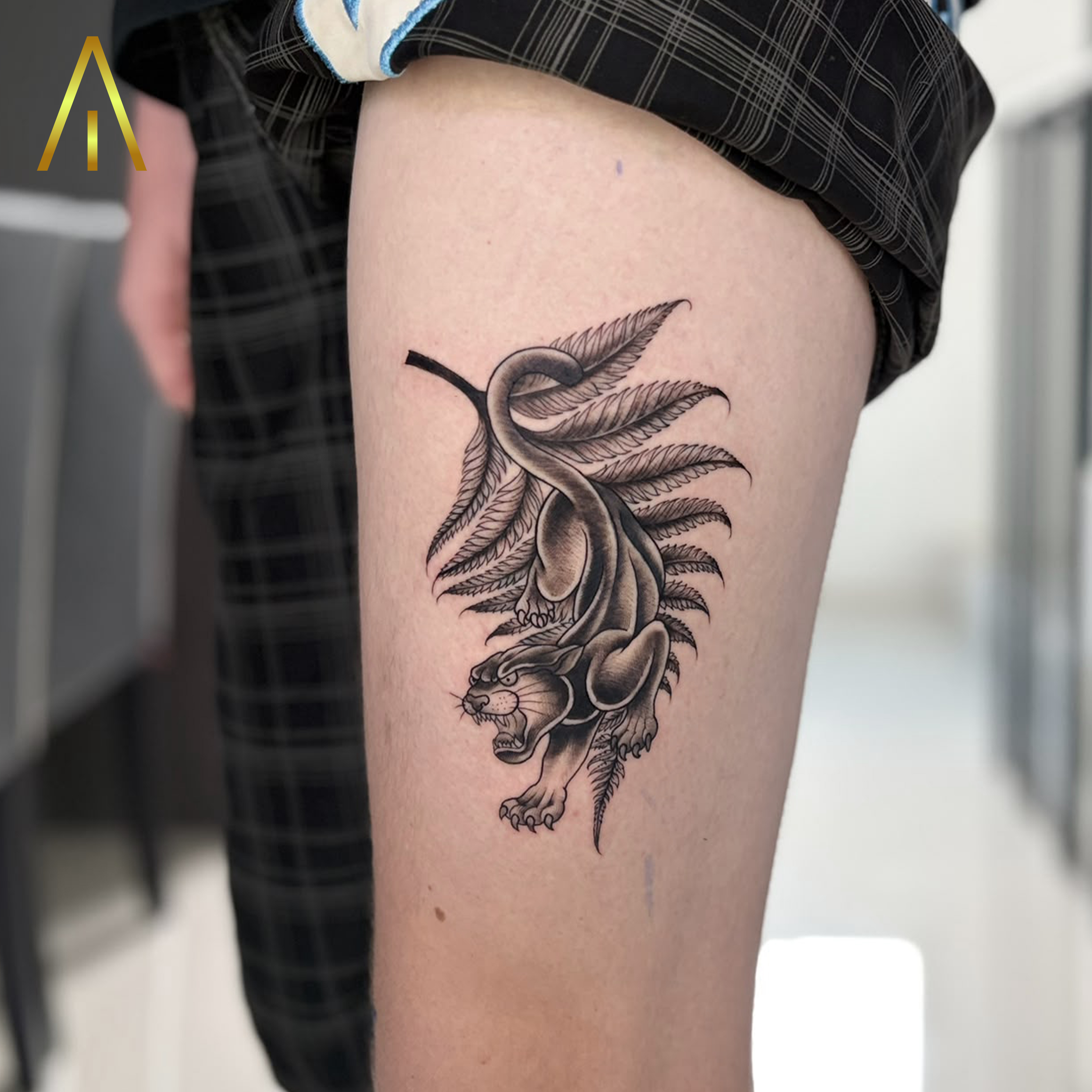 Jean panther climbing down fern branch minimal thigh tattoo Chiang Mai