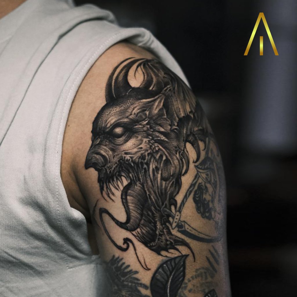 Black and grey demon wolf head tattoo on upper arm Chiang Mai