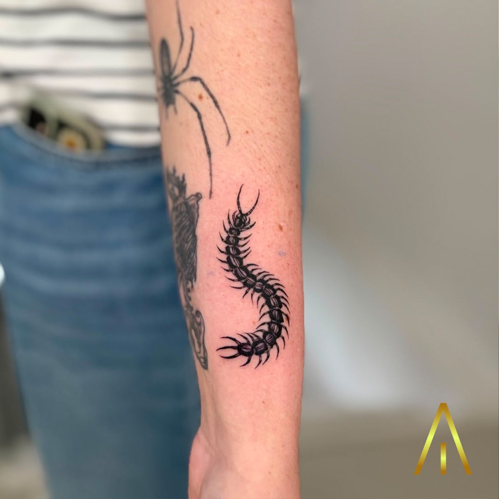Blackwork centipede tattoo on forearm Chiang Mai