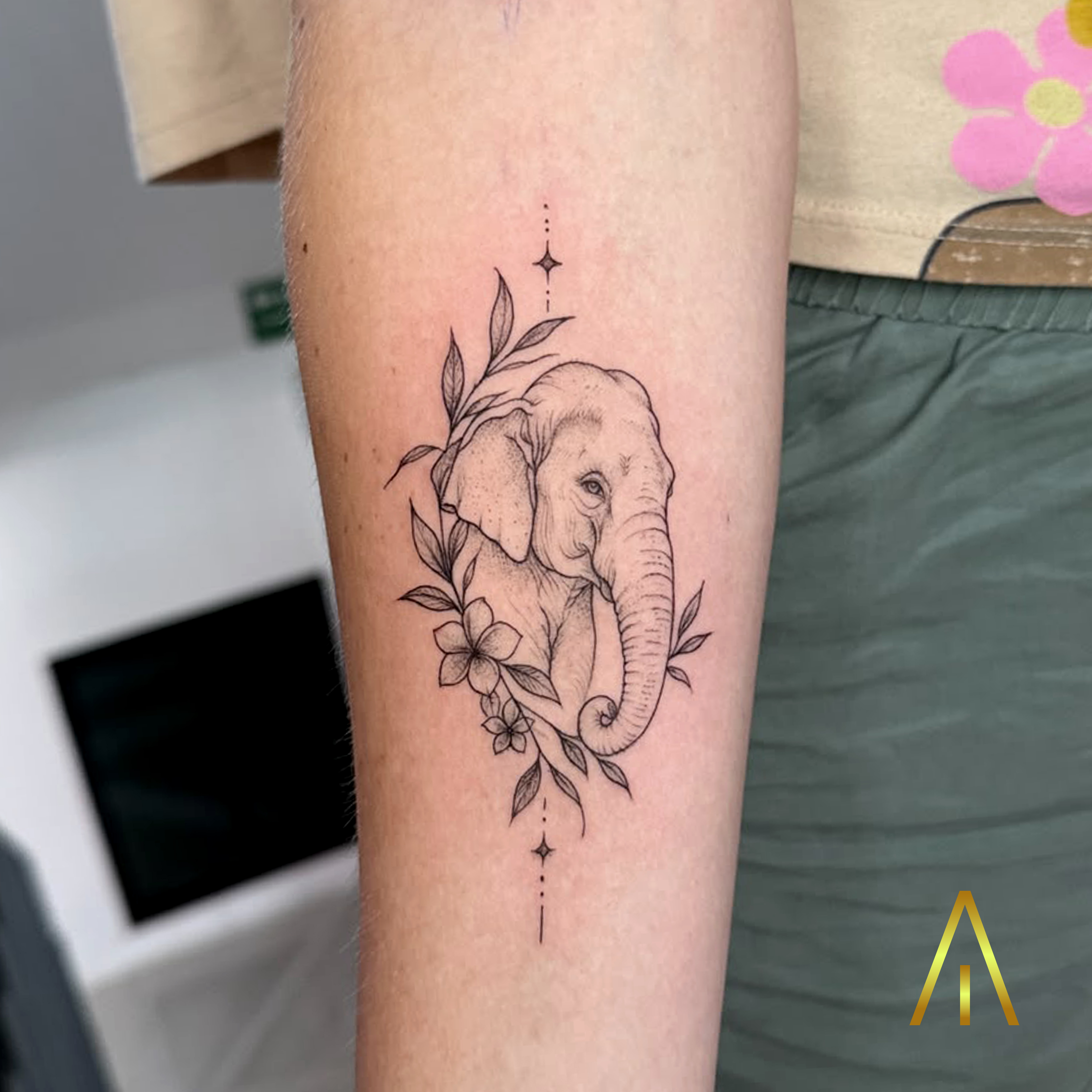 Mimi minimal elephant portrait with flowers upper arm tattoo Chiang Mai