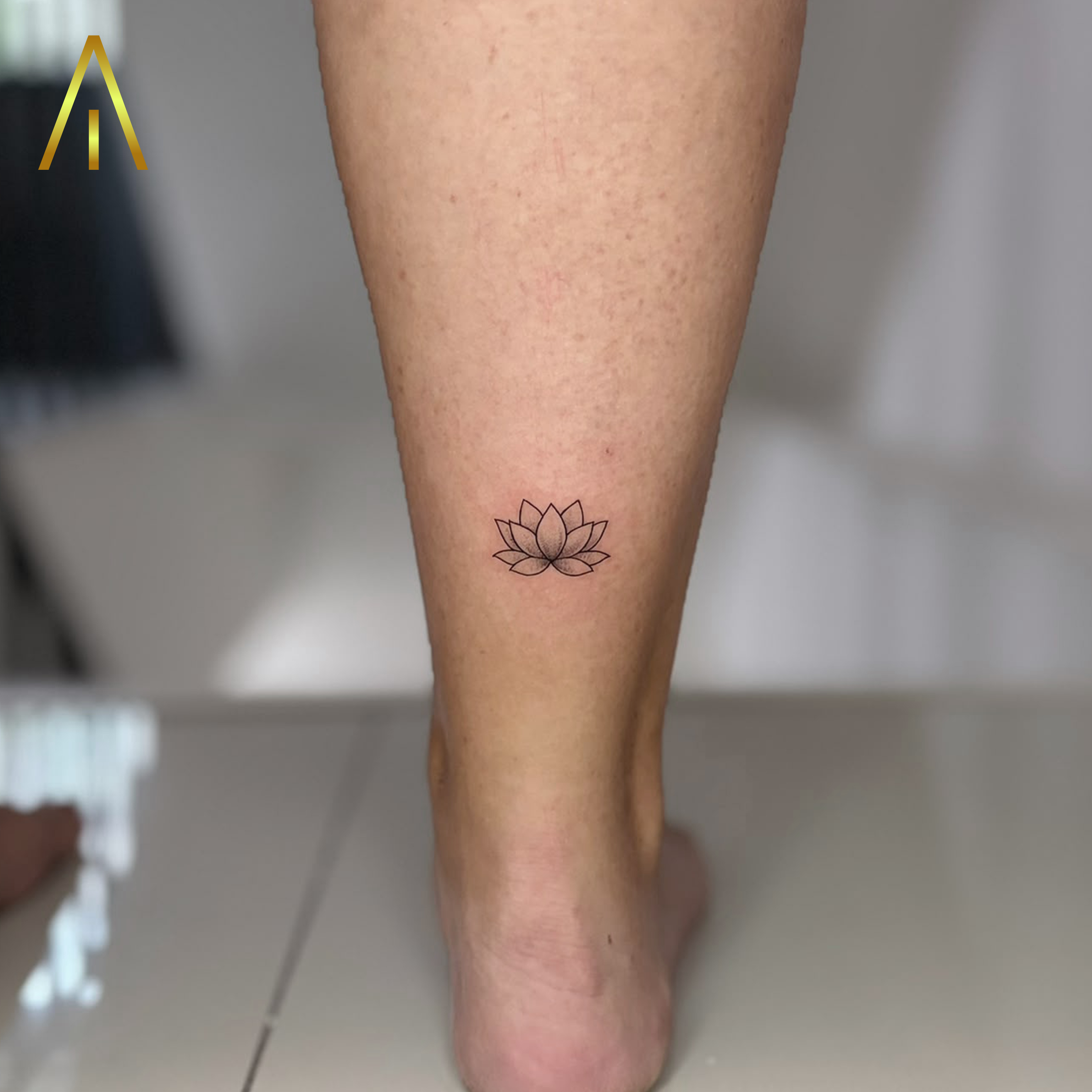 Mimi lotus flower fine line calf ankle tattoo Chiang Mai
